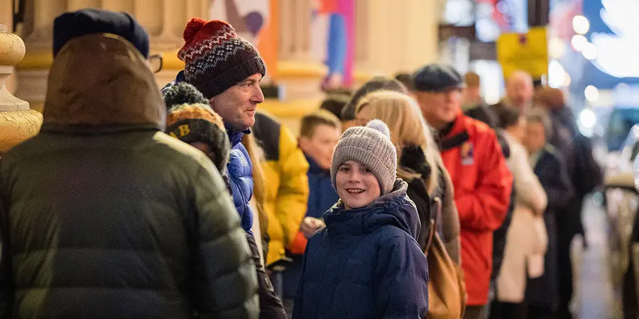 Children and adults queuing outside the Ri to get into the Christmas Lectures