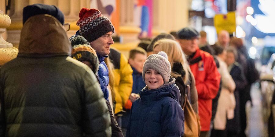 Children and adults queuing outside the Ri to get into the Christmas Lectures