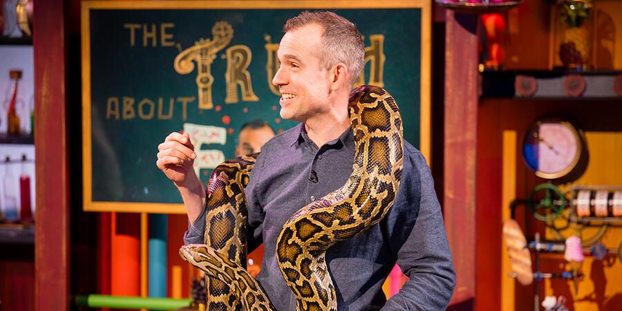 Chris van Tulleken in the 2024 Christmas Lectures, holding a Burmese python
