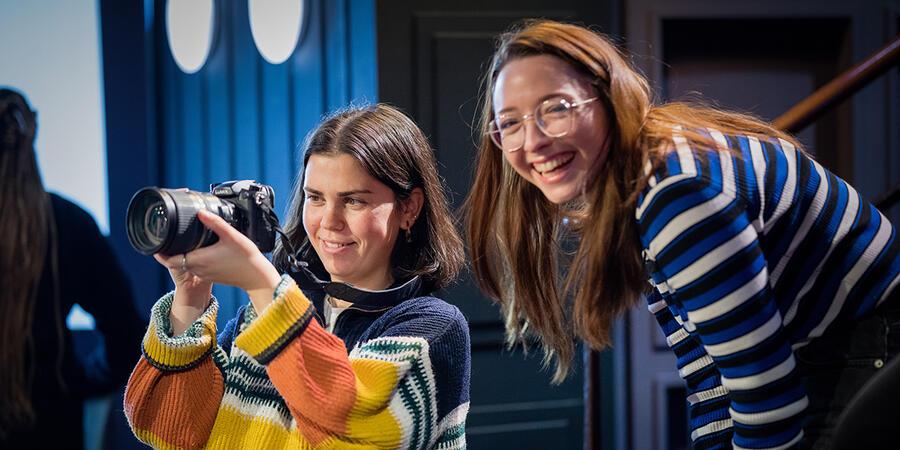 Two smiling young women looking into a camera