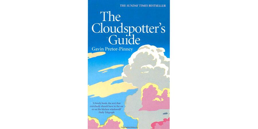 The cover of the cloudspotter's guide book, featuring fluffy white and pink illustrated clouds