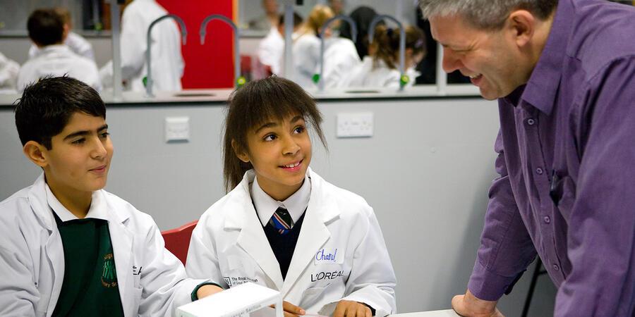 Children wearing white lab coats in the L'Oreal Young Scientist Centre