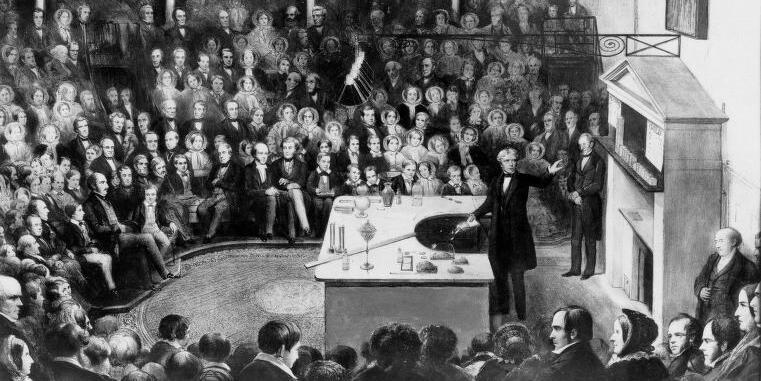 A drawing of Michael Faraday lecturing in the Ri Theatre in 1855. We can see an audience of adult men and women observing his demonstration
