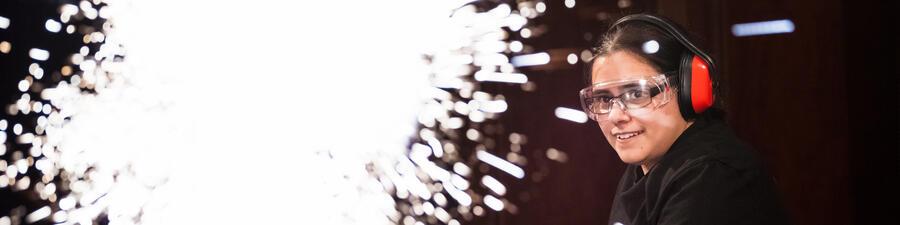 A woman showing a demo with lots of sparks