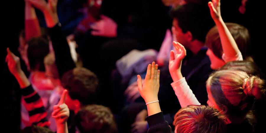 Children raising their hands