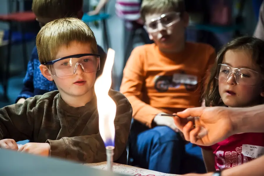 Children look at a bunsen burner flame
