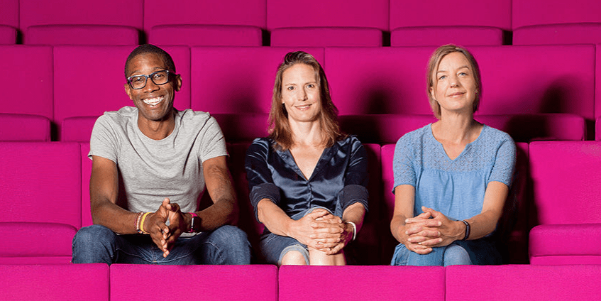 2020 Christmas Lecturers Chris Jackson, Helen Czerski and Tara Shine sitting in the magenta seats of the Ri Theatre
