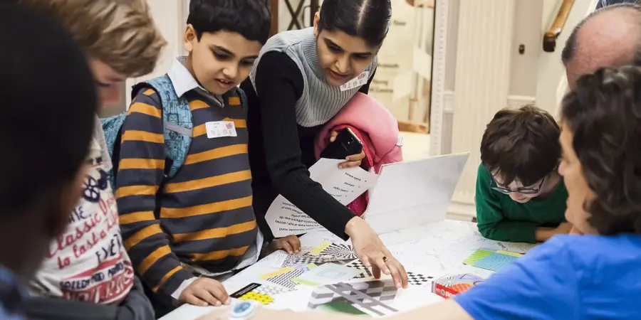 Children looking at learning materials on a table