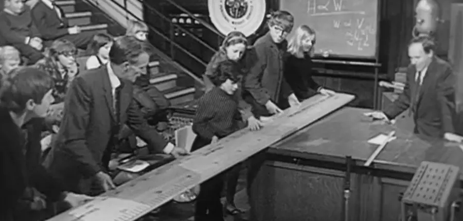 Bill Coates during the 1968 Christmas Lectures, helping children with a demo involving a giant ruler