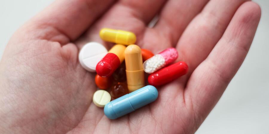 A hand holding several different tablets