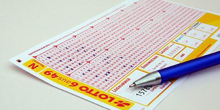A lotto ticket with numbers crossed out in blue pen
