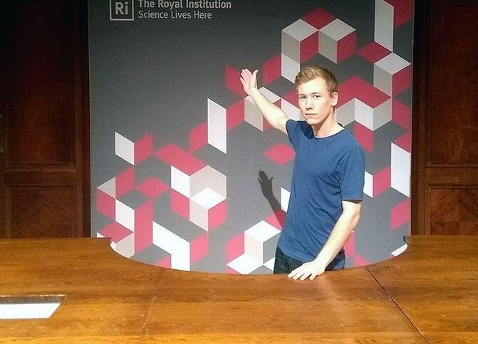 Matt standing behind our lecture theatre desk