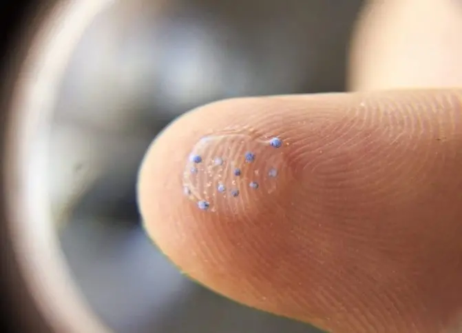 Microplastic magnified on a finger