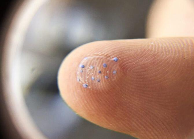 Microplastic magnified on a finger