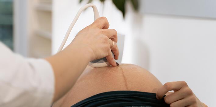 A pregnant person receiving a scan