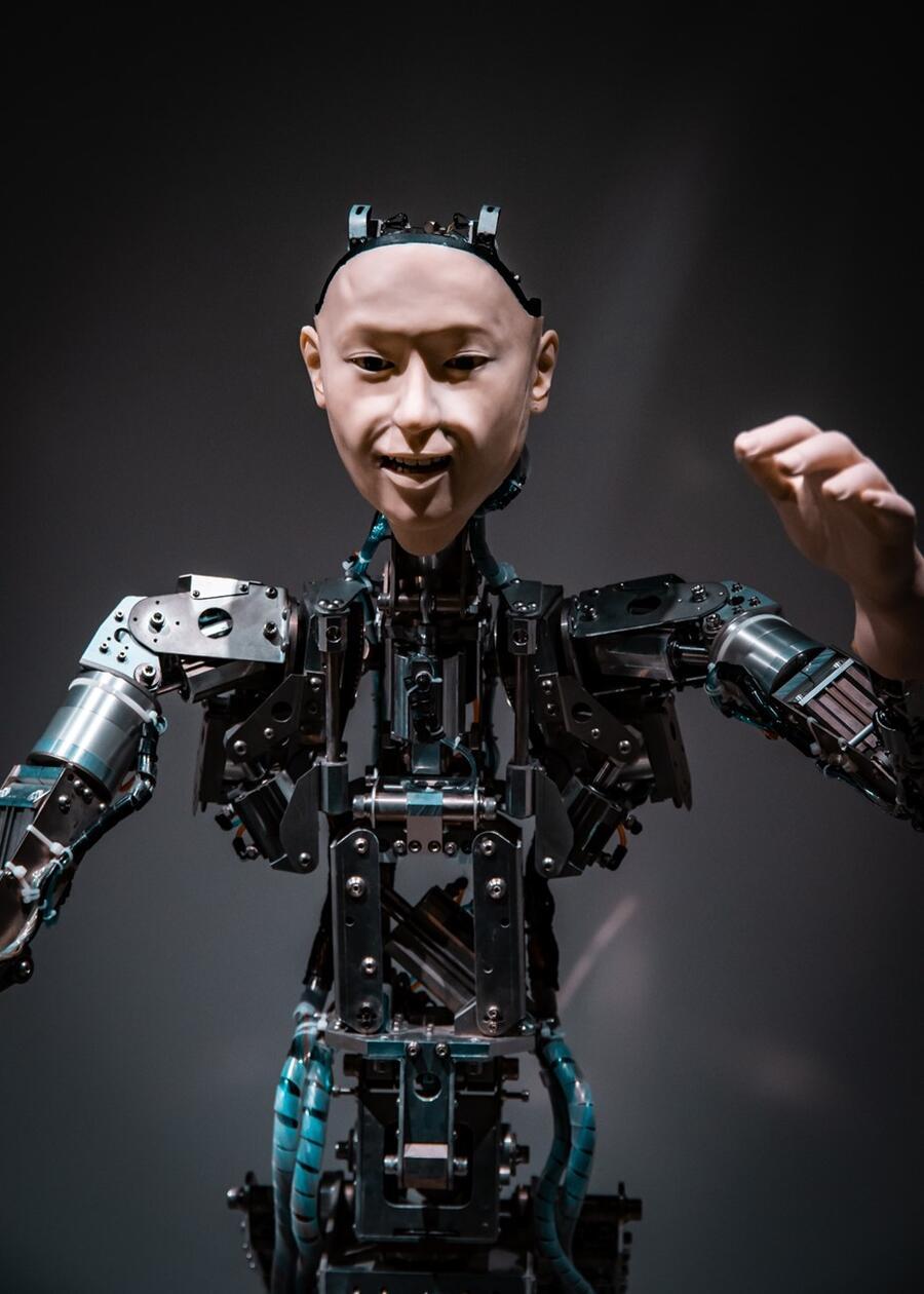 A robot with a human face. Its arms and body show its wires and circuits