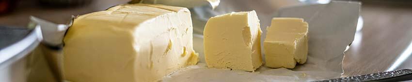 A soft block of butter on a cutting board