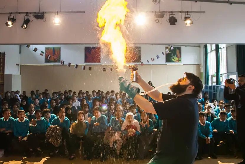 A flame throwing demo in front of an amazed group of schoolchildren