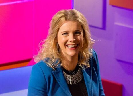 Danielle George smiling, in front of  a colourful backdrop