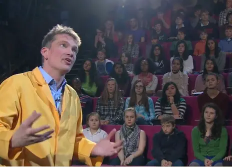 Peter Wother talking to a crowd of seated children during his CHRISTMAS LECTURE