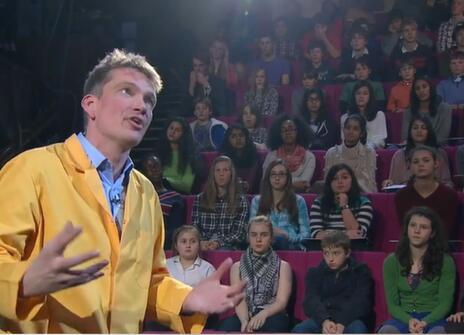 Peter Wother talking to a crowd of seated children during his CHRISTMAS LECTURE