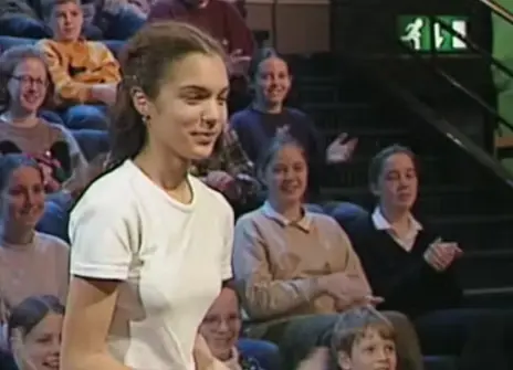 A teenager walking to the stage of the Ri Theatre