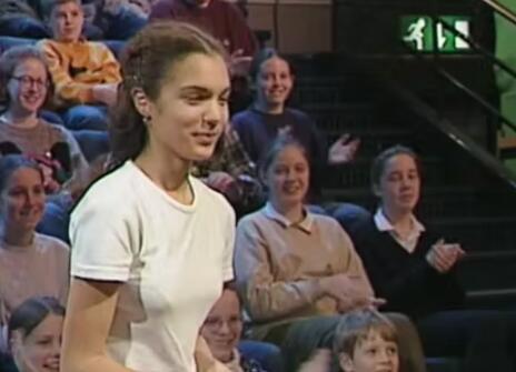 A teenager walking to the stage of the Ri Theatre