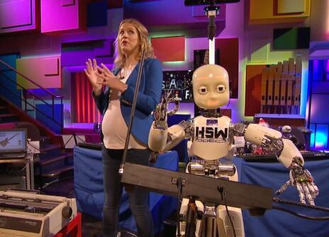 Danielle George  standing next to a robot in the Ri Theatre