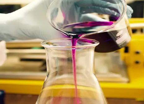 Two science beakers with coloured liquid
