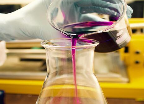 Two science beakers with coloured liquid