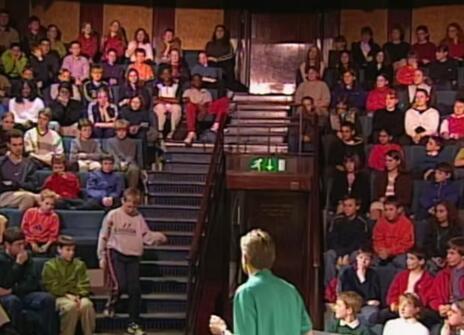 Neil Johnson talking to a crowd of children in the Ri theatre