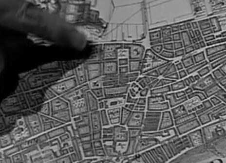 a finger pointing to a part of a map of london 