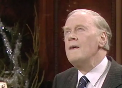 RV Jones speaking in the Ri Theatre, with a christmas tree in the background