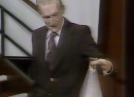 David Phillips holding a beaker filled with smoke