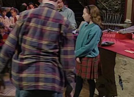 A man with his back turned and a child in the Ri theatre