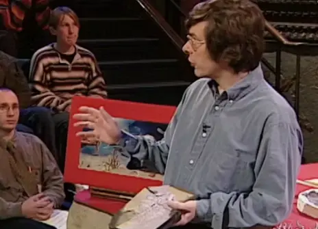 Simon Conway Morris holding a fossil in the Ri theatre