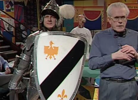 Charles Stirling standing next to a man dressed as a knight in armour
