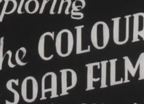 still from the soap film series, with printed text saying 'THE COLOURS OF SOAP FILMS' written in cursive