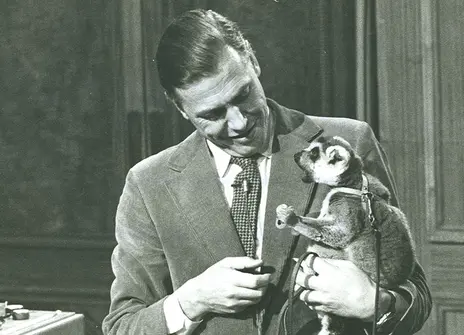 David Attenborough on the set of his Christmas Lectures, holding Tammy the lemur