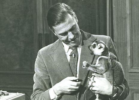 David Attenborough on the set of his Christmas Lectures, holding Tammy the lemur