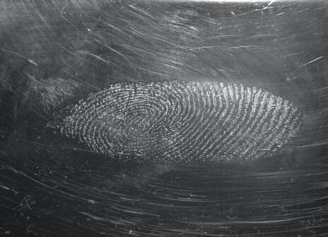 sweat-fingerprint on a CD-cover photographed in reflexlight