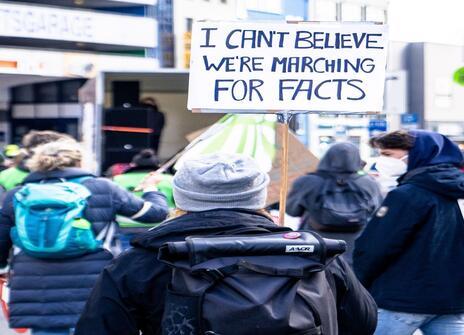 people holding sign at a protest 