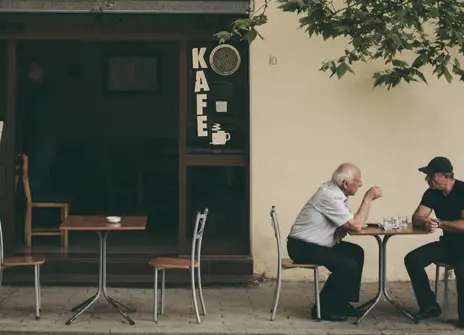 Men conversing outside a house