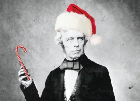 A picture of Michael Faraday, with a bright red hat and a candy cane photoshopped on him