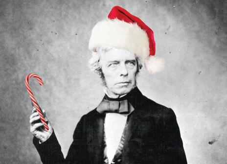 A picture of Michael Faraday, with a bright red hat and a candy cane photoshopped on him
