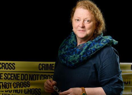 Sue Black stands in front of crime scene tape