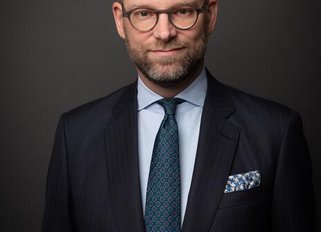 A picture of Vincent Nobel, he is a white man wearing glasses and a navy suit