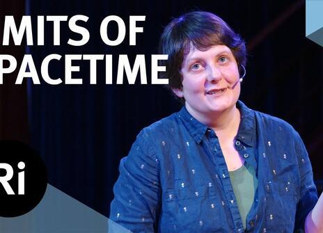 The speaker faces the front of the stage, hands slightly raised. Overlayed are the words 'LIMITS OF SPACETIME' alongside the Royal Institution's logo.