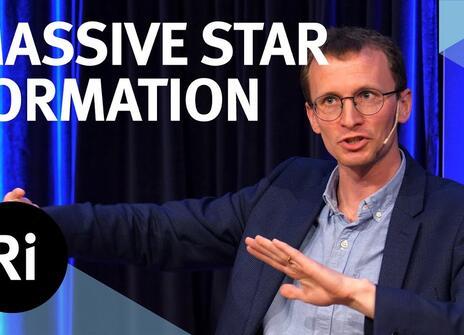 The speaker faces the front of the stage, hands slightly raised. Overlayed are the words 'MASSIVE STAR FORMATION' alongside the Royal Institution's logo.