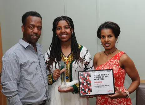 Hasset Kifle and her parents celebrate her award